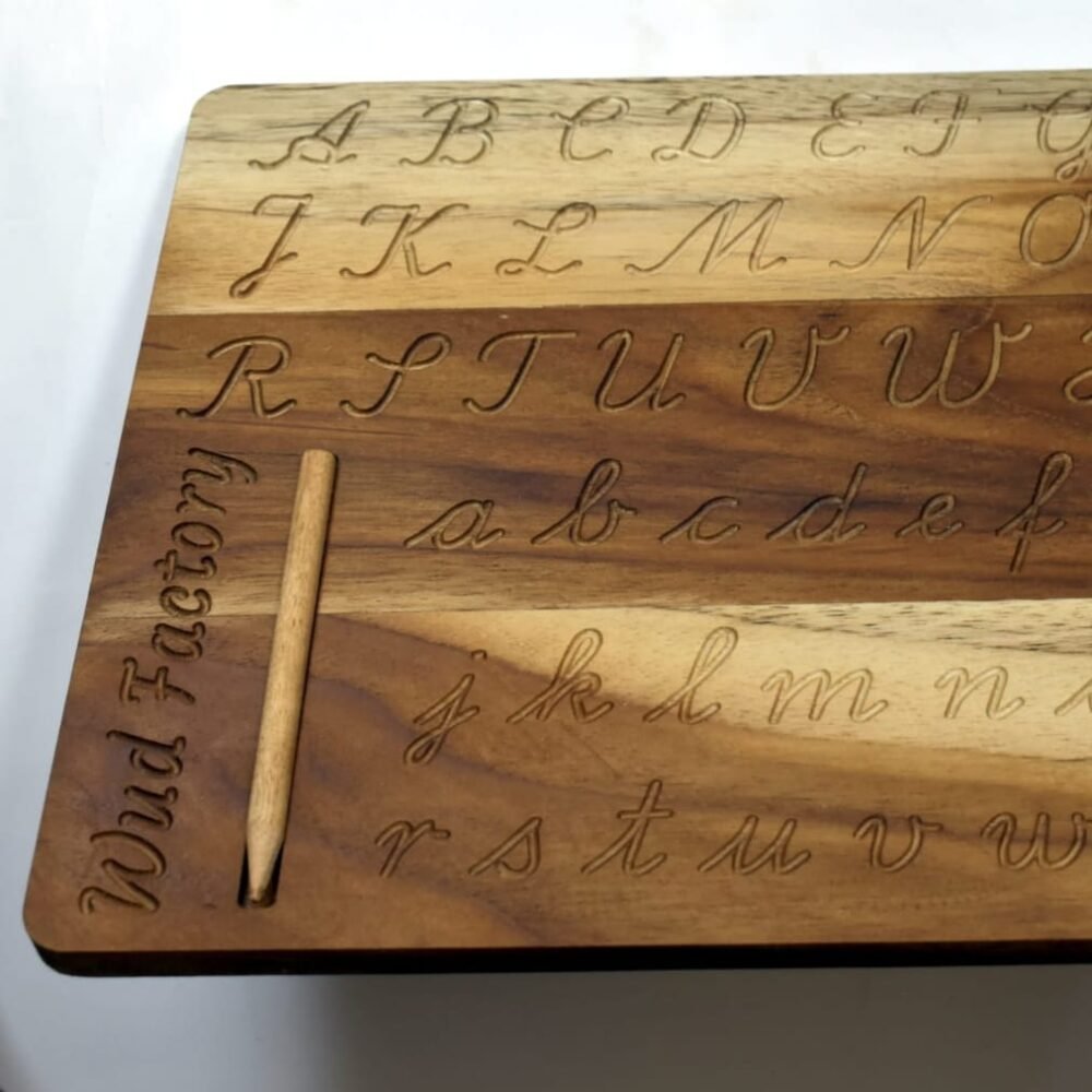 Close-up of the wooden letter tracing board showing engraved letters
